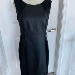 Black dress with sexy back zipper. Faux leather panel on front and back. Size 10